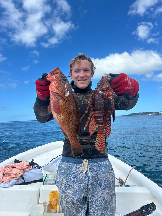 Diver with coral trout and lionfish