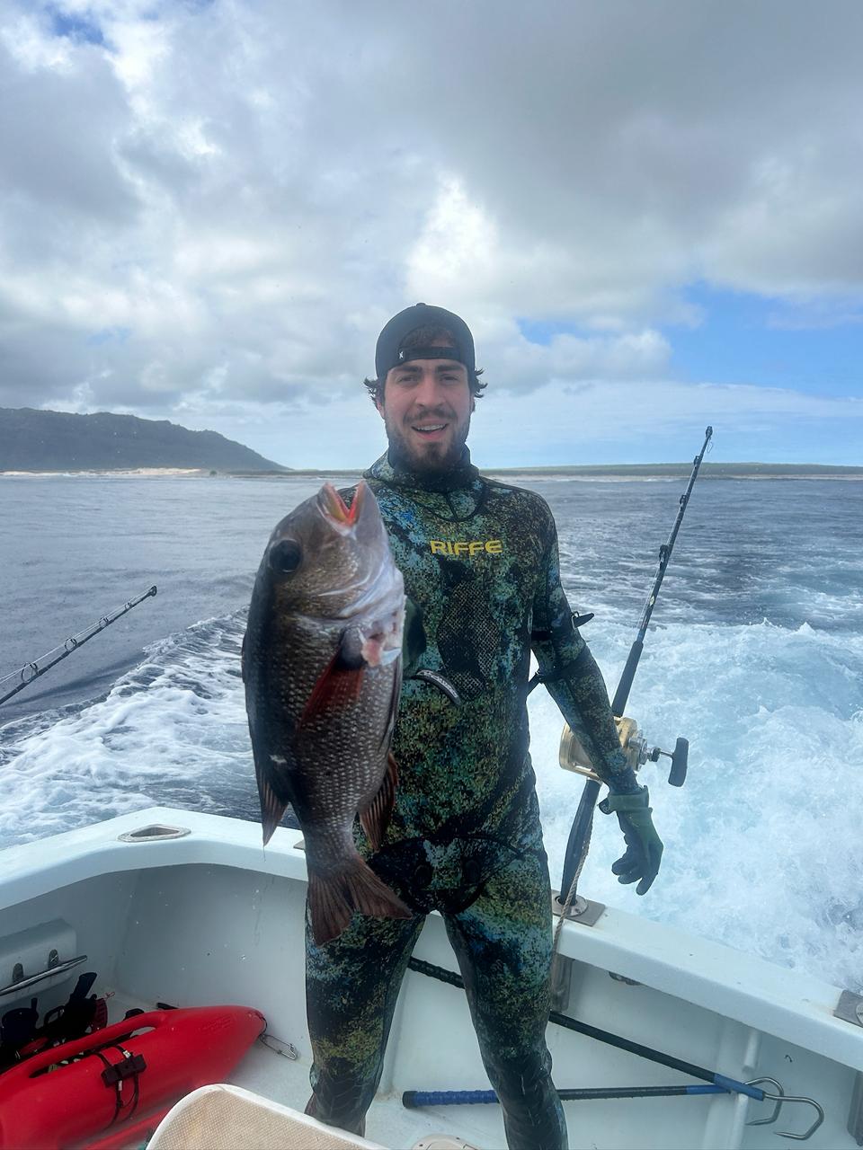 Diver with snapper on boat