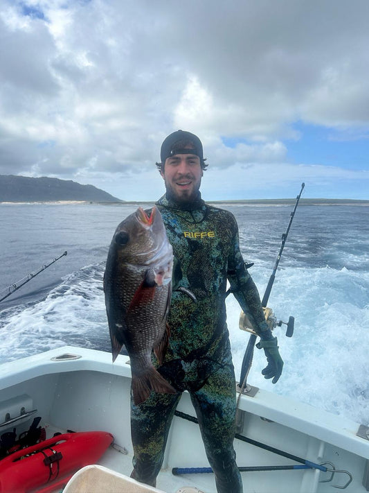 Diver with snapper on boat